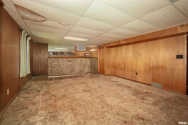 2518 13th St, Rock Island, IL 61201 - finished below grade area with a drop ceiling, wooden walls, and carpet flooring