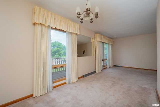 2518 13th St, Rock Island, IL 61201 - empty room featuring a chandelier and light colored carpet