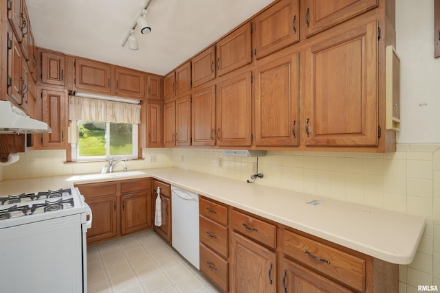 2518 13th St, Rock Island, IL 61201 - kitchen with under cabinet range hood, white appliances, brown cabinets, light floors, and light countertops