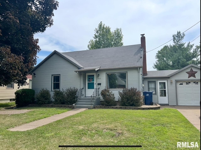402 SW 7th Ave, Aledo, IL 61231 - view of front of house with a chimney, a front yard, a garage, and driveway