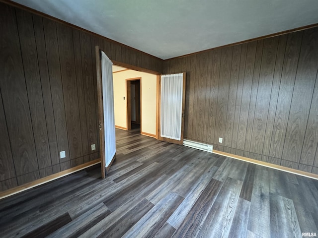 208BAGGOTT None St, Zeigler, IL 62999 - empty room featuring a baseboard heating unit, wood finished floors, and wood walls