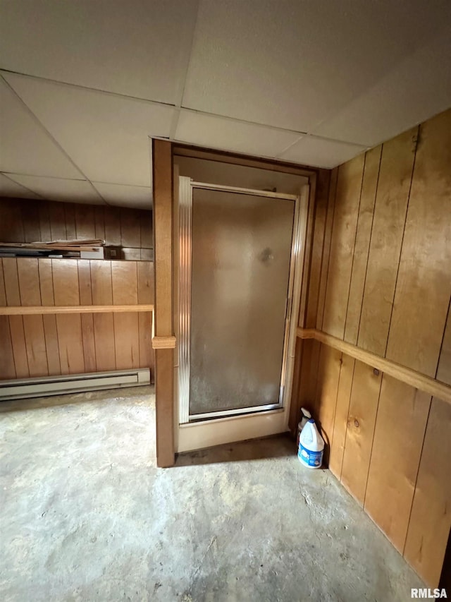 208BAGGOTT None St, Zeigler, IL 62999 - detailed view of concrete floors, a baseboard radiator, a drop ceiling, and wooden walls