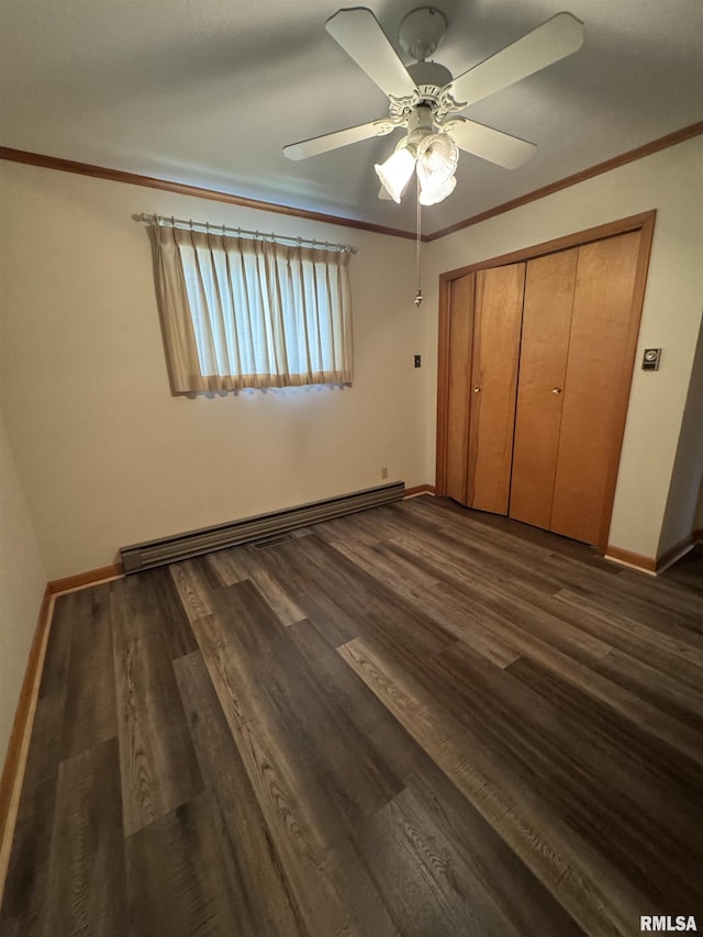 208BAGGOTT None St, Zeigler, IL 62999 - unfurnished bedroom featuring a baseboard radiator, crown molding, dark wood-style floors, and a closet