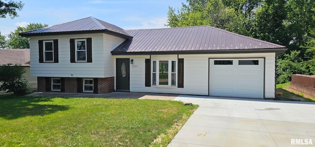 2337 Cameron Dr, Clinton, IA 52732 - tri-level home featuring an attached garage, a front yard, driveway, and a metal roof