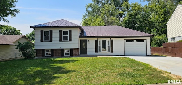 2337 Cameron Dr, Clinton, IA 52732 - split level home featuring an attached garage, driveway, and a metal roof