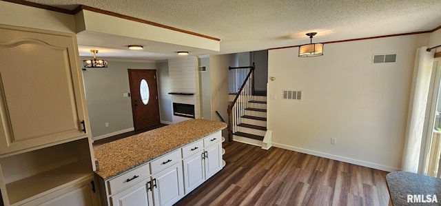 2337 Cameron Dr, Clinton, IA 52732 - kitchen featuring dark wood-style floors, a textured ceiling, ornamental molding, decorative light fixtures, and a chandelier