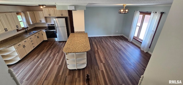 2337 Cameron Dr, Clinton, IA 52732 - kitchen with appliances with stainless steel finishes, a textured ceiling, healthy amount of natural light, open shelves, and dark wood-style flooring