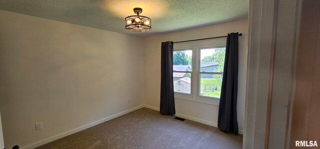 2337 Cameron Dr, Clinton, IA 52732 - spare room featuring carpet flooring, a chandelier, and a textured ceiling