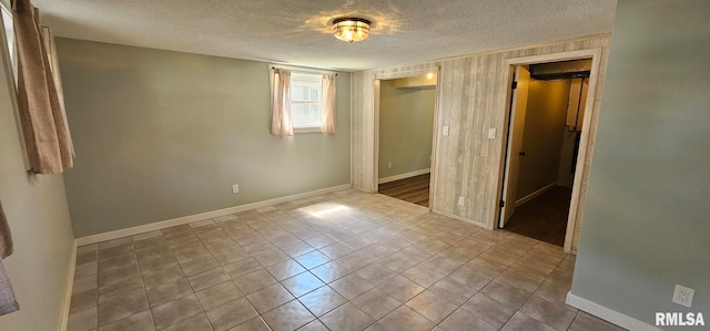 2337 Cameron Dr, Clinton, IA 52732 - unfurnished bedroom with a textured ceiling, a closet, and tile patterned floors