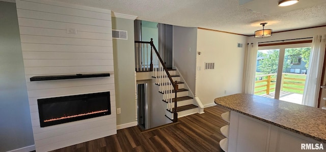 2337 Cameron Dr, Clinton, IA 52732 - staircase with wood finished floors, a textured ceiling, and a fireplace