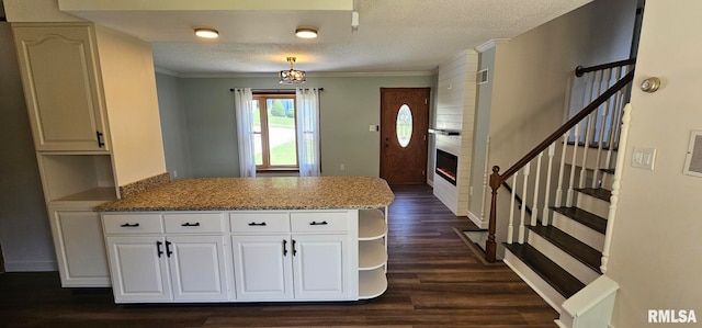 2337 Cameron Dr, Clinton, IA 52732 - kitchen featuring a peninsula, open shelves, a textured ceiling, dark wood finished floors, and white cabinets