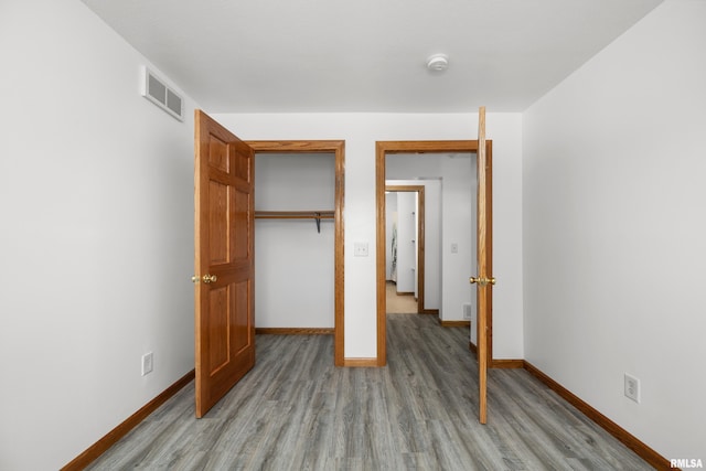 222 6th St, Buffalo, IA 52728 - unfurnished bedroom featuring light wood-style flooring and a closet