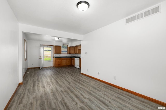 222 6th St, Buffalo, IA 52728 - unfurnished living room featuring baseboards and dark wood-type flooring