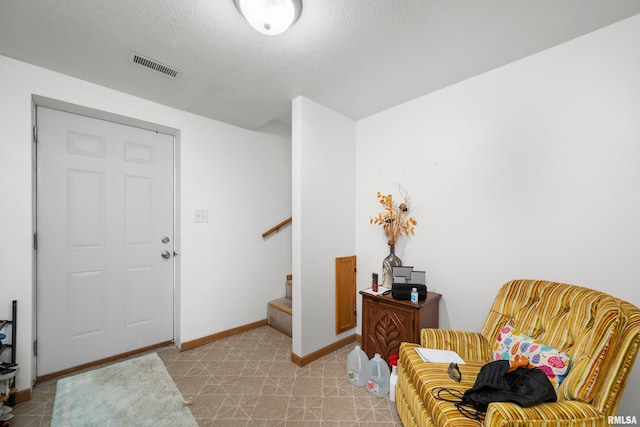 222 6th St, Buffalo, IA 52728 - entrance foyer featuring stairway and a textured ceiling