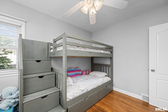 4040 27th Ave, Rock Island, IL 61201 - bedroom with wood finished floors, multiple windows, and a ceiling fan