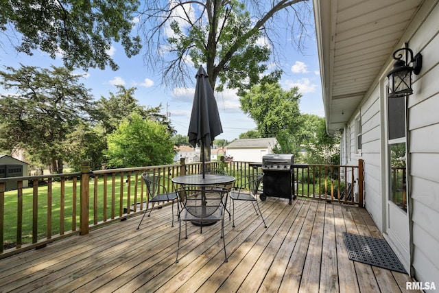 4040 27th Ave, Rock Island, IL 61201 - wooden deck with outdoor dining area, a yard, and area for grilling