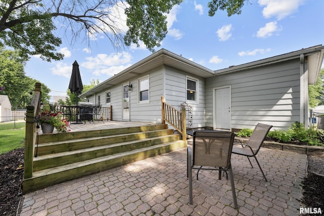4040 27th Ave, Rock Island, IL 61201 - rear view of property featuring outdoor dining area, a patio, and a deck
