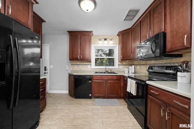 4040 27th Ave, Rock Island, IL 61201 - kitchen with black appliances, tasteful backsplash, and light countertops