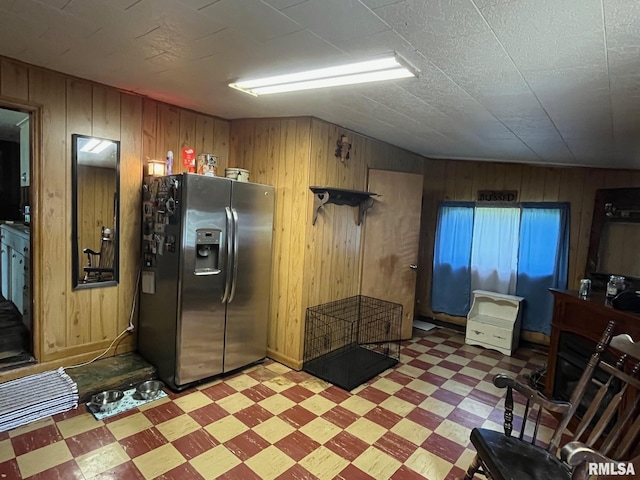 247 W Garfield St, Kewanee, IL 61443 - kitchen with stainless steel refrigerator with ice dispenser, light flooring, and wood walls