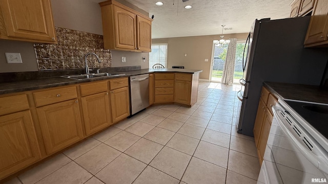 11279 Nora Ln, Carterville, IL 62918 - kitchen featuring appliances with stainless steel finishes, a peninsula, a chandelier, light tile patterned flooring, and tasteful backsplash