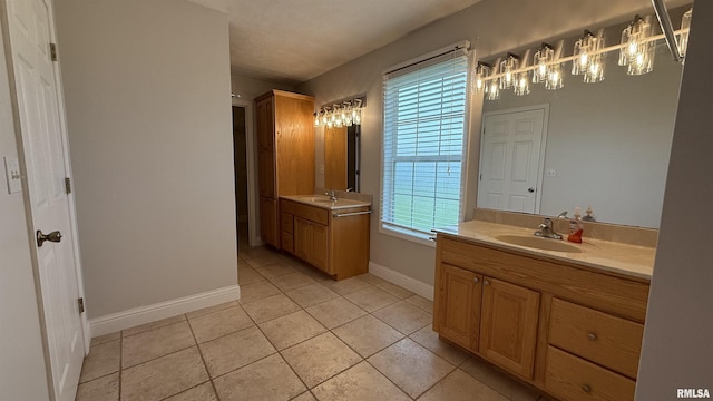 11279 Nora Ln, Carterville, IL 62918 - full bathroom featuring two vanities, tile patterned floors, and a chandelier