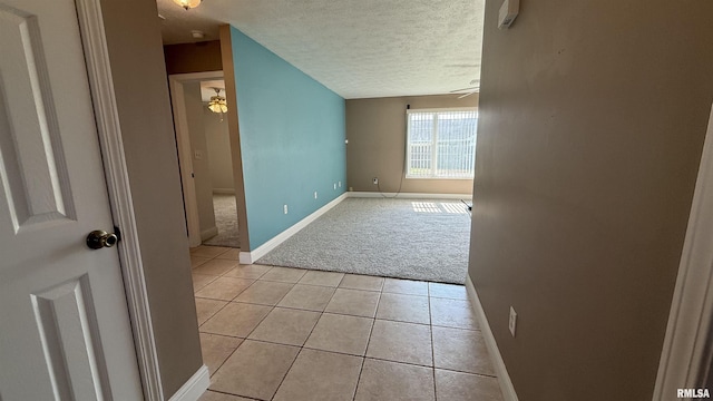 11279 Nora Ln, Carterville, IL 62918 - spare room featuring light carpet, a textured ceiling, light tile patterned flooring, and ceiling fan