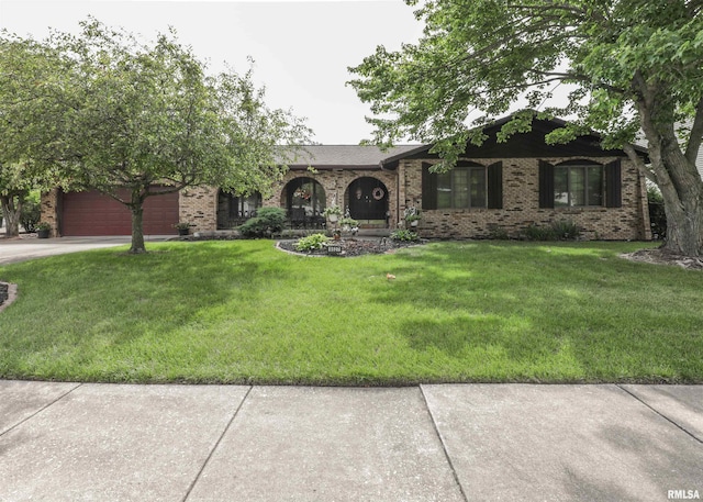 8527 W 17th St, Rock Island, IL 61201 - ranch-style home featuring a front lawn, concrete driveway, brick siding, and a garage