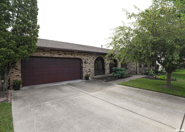 8527 W 17th St, Rock Island, IL 61201 - ranch-style home with driveway, a garage, brick siding, and a front lawn