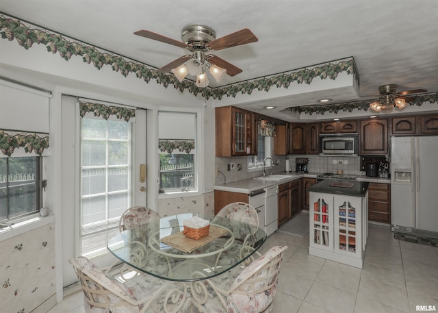 8527 W 17th St, Rock Island, IL 61201 - kitchen featuring white appliances, a ceiling fan, light countertops, and tasteful backsplash
