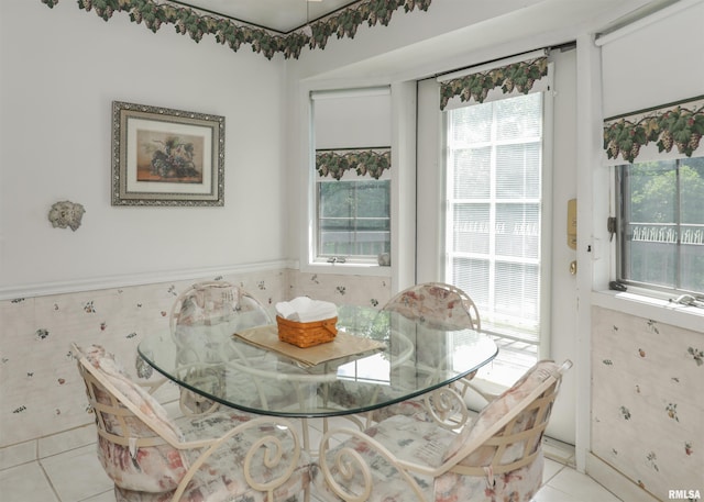 8527 W 17th St, Rock Island, IL 61201 - dining space featuring light tile patterned flooring, plenty of natural light, and a wainscoted wall