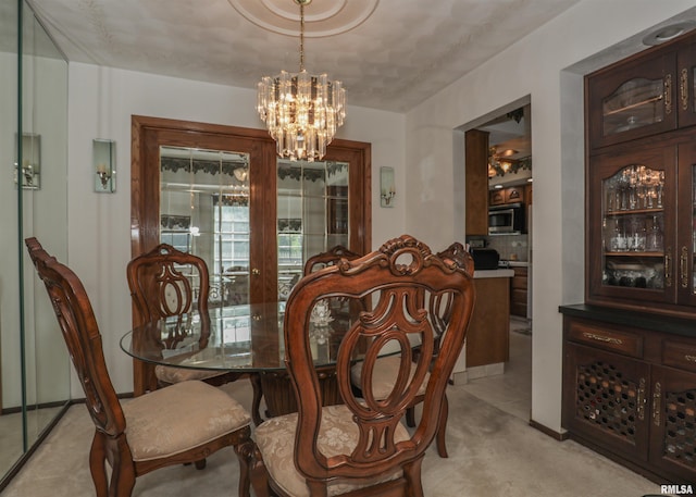 8527 W 17th St, Rock Island, IL 61201 - dining space with a chandelier and light carpet