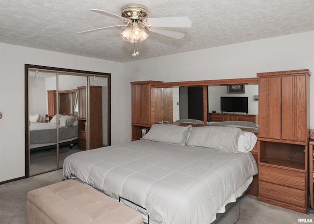 8527 W 17th St, Rock Island, IL 61201 - bedroom featuring light colored carpet, a closet, a ceiling fan, and a textured ceiling