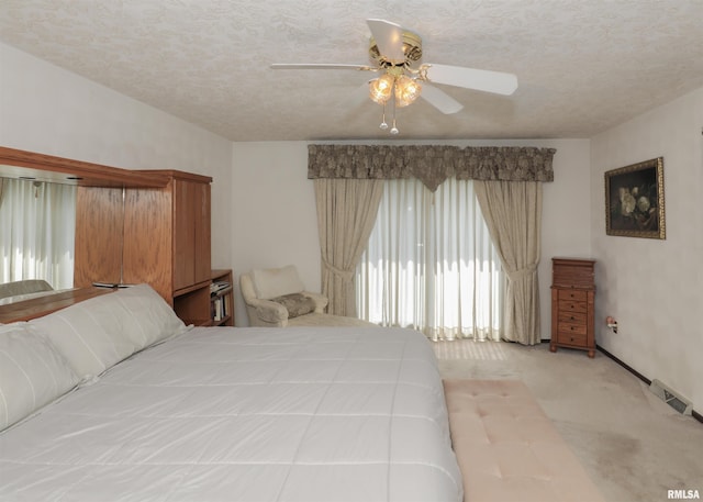 8527 W 17th St, Rock Island, IL 61201 - carpeted bedroom with a textured ceiling and ceiling fan