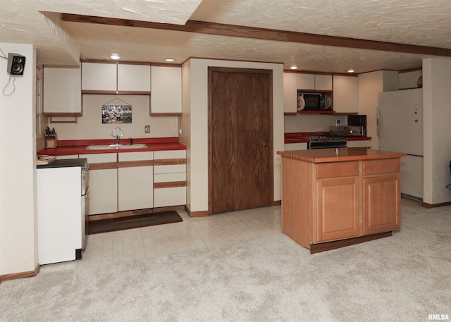 8527 W 17th St, Rock Island, IL 61201 - kitchen featuring black microwave, freestanding refrigerator, stainless steel range with gas stovetop, a textured ceiling, and recessed lighting