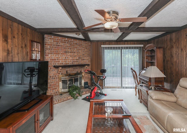 8527 W 17th St, Rock Island, IL 61201 - carpeted living area featuring wooden walls, a ceiling fan, a textured ceiling, beamed ceiling, and a brick fireplace