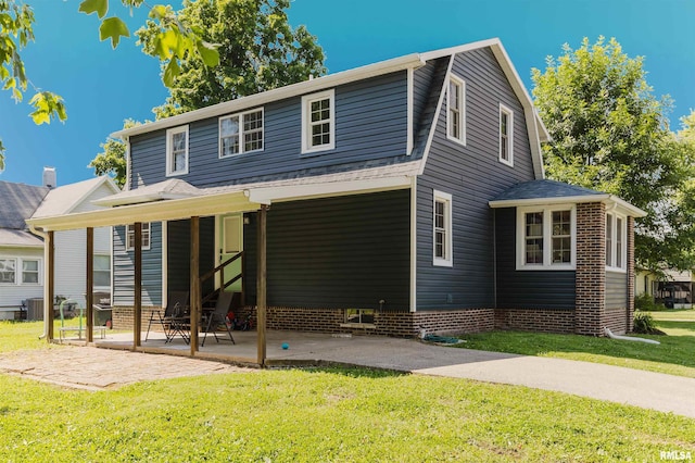 401 W Grand Ave, Carterville, IL 62918 - view of front of house with a front lawn, a patio, and a gambrel roof