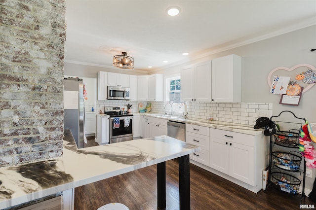 401 W Grand Ave, Carterville, IL 62918 - kitchen featuring appliances with stainless steel finishes, ornamental molding, dark wood-style flooring, a peninsula, and decorative backsplash