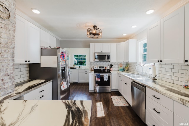 401 W Grand Ave, Carterville, IL 62918 - kitchen featuring appliances with stainless steel finishes, backsplash, dark wood finished floors, white cabinetry, and ornamental molding