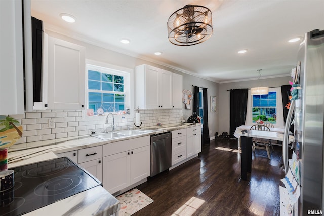 401 W Grand Ave, Carterville, IL 62918 - kitchen with stainless steel appliances, crown molding, light countertops, white cabinets, and decorative backsplash