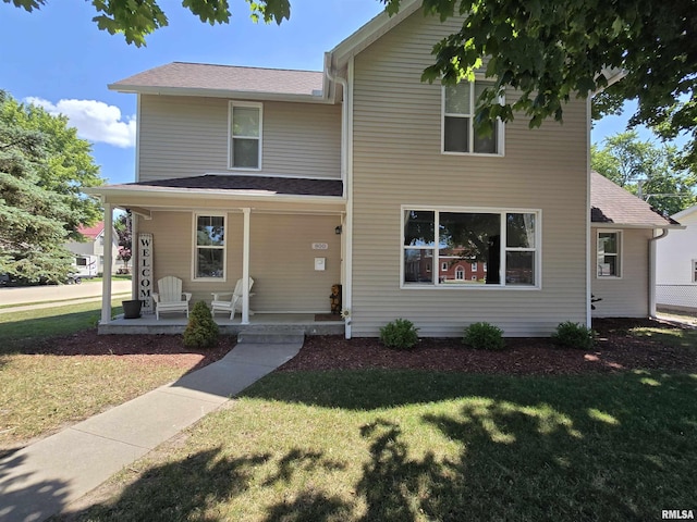 800 13th Ave, Fulton, IL 61252 - view of front facade with covered porch, a front yard, and roof with shingles