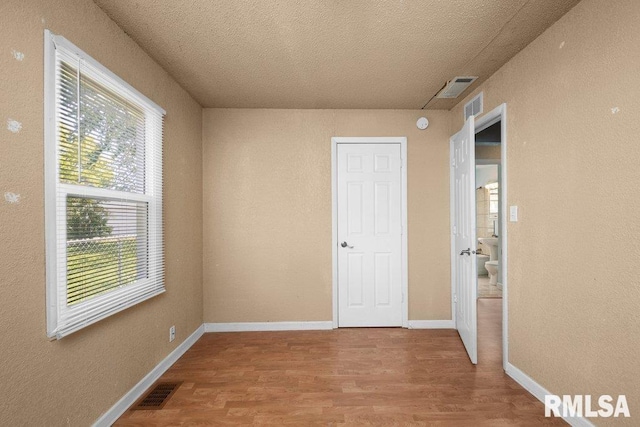 2043 30th St, Rock Island, IL 61201 - empty room with wood finished floors and a textured ceiling