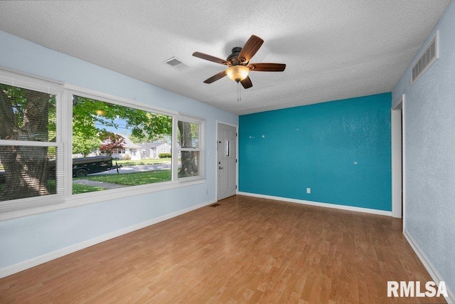2043 30th St, Rock Island, IL 61201 - unfurnished room featuring a textured ceiling, wood finished floors, and a ceiling fan