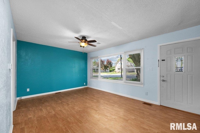 2043 30th St, Rock Island, IL 61201 - entryway featuring wood finished floors, ceiling fan, and a textured ceiling