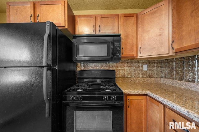 2043 30th St, Rock Island, IL 61201 - kitchen featuring black appliances, brown cabinetry, and decorative backsplash