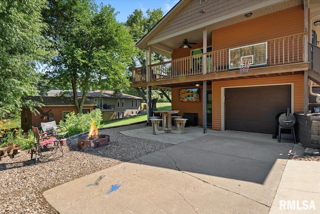 129 Glenview Dr, Sherrard, IL 61281 - view of patio / terrace featuring an outdoor fire pit, a garage, concrete driveway, and ceiling fan