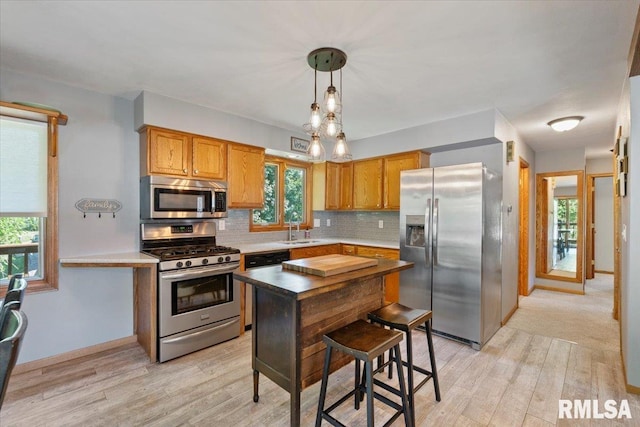 129 Glenview Dr, Sherrard, IL 61281 - kitchen with stainless steel appliances, decorative backsplash, and light wood-style floors