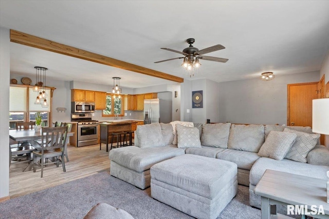 129 Glenview Dr, Sherrard, IL 61281 - living area with light wood finished floors, a ceiling fan, beamed ceiling, and a chandelier