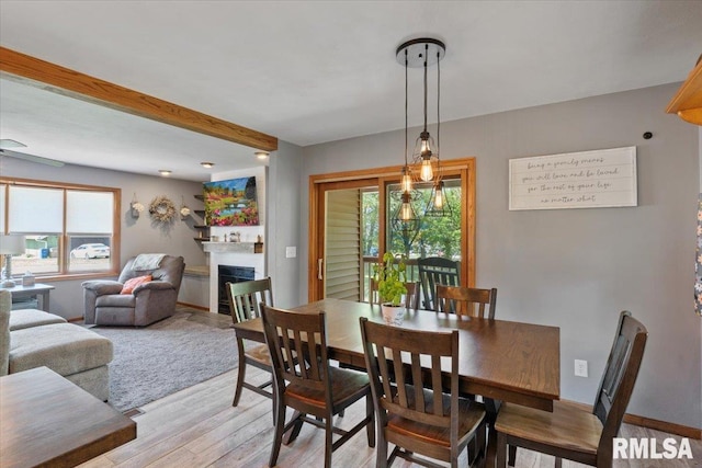 129 Glenview Dr, Sherrard, IL 61281 - dining room with light wood finished floors, a fireplace, and beamed ceiling