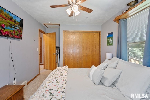 129 Glenview Dr, Sherrard, IL 61281 - bedroom with light carpet, a closet, and a ceiling fan