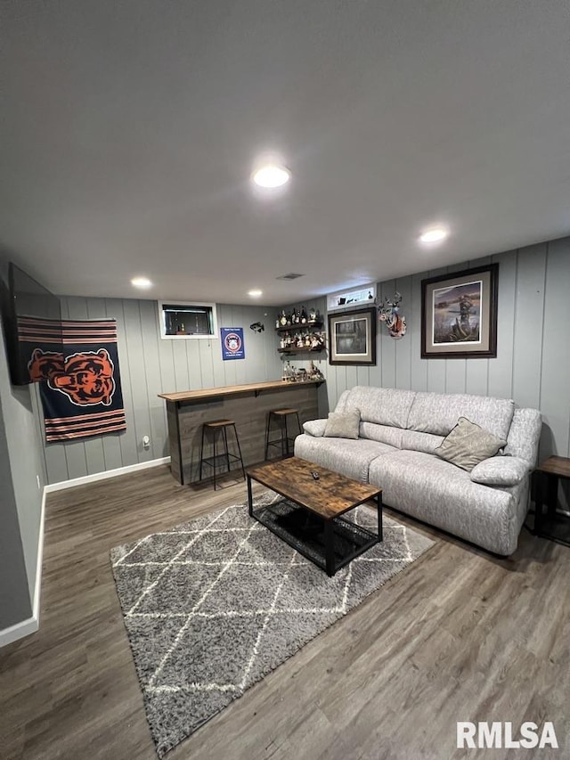 129 Glenview Dr, Sherrard, IL 61281 - living area with a dry bar, wood finished floors, and a decorative wall